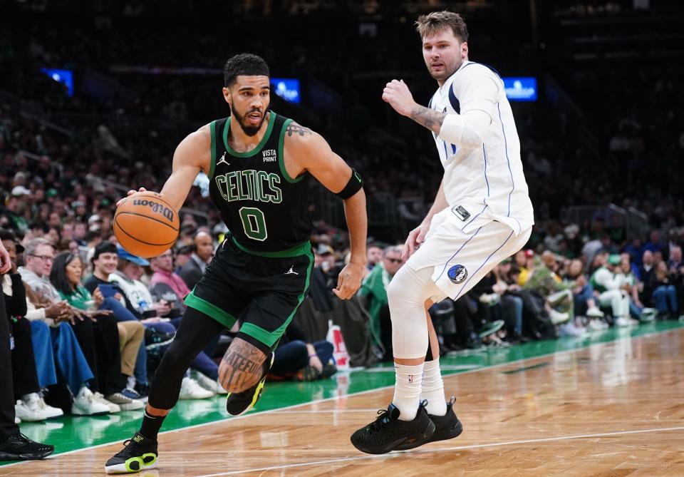 Mar 1, 2024; Boston, Massachusetts, USA; Boston Celtics forward Jayson Tatum (0) drives the ball against Dallas Mavericks guard Luka Doncic (77) in the second half at TD Garden. Mandatory Credit: David Butler II-USA TODAY Sports