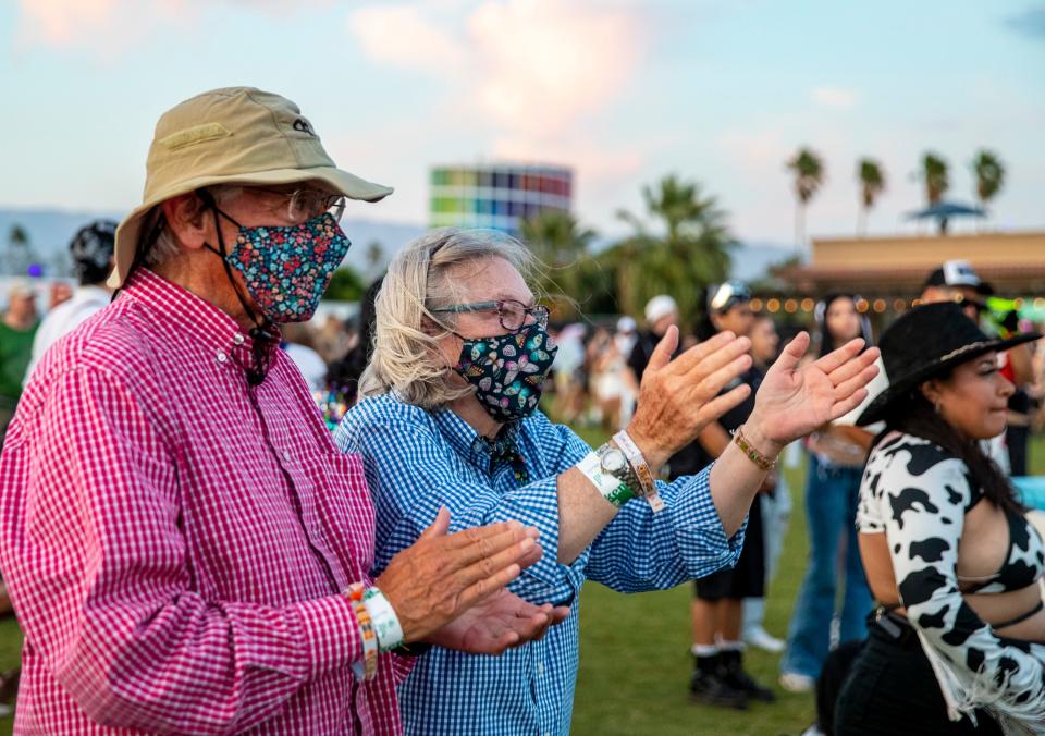 Bob and Sally Arroyo clap along to a set by Adam Ten x Mita Gami during the Coachella Valley Music and Arts Festival in Indio, Calif., Friday, April 19, 2024.