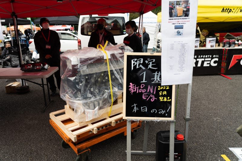 a brand-new nissan gt-r engine photographed in plastic wrap and still bolted to its original storage crate