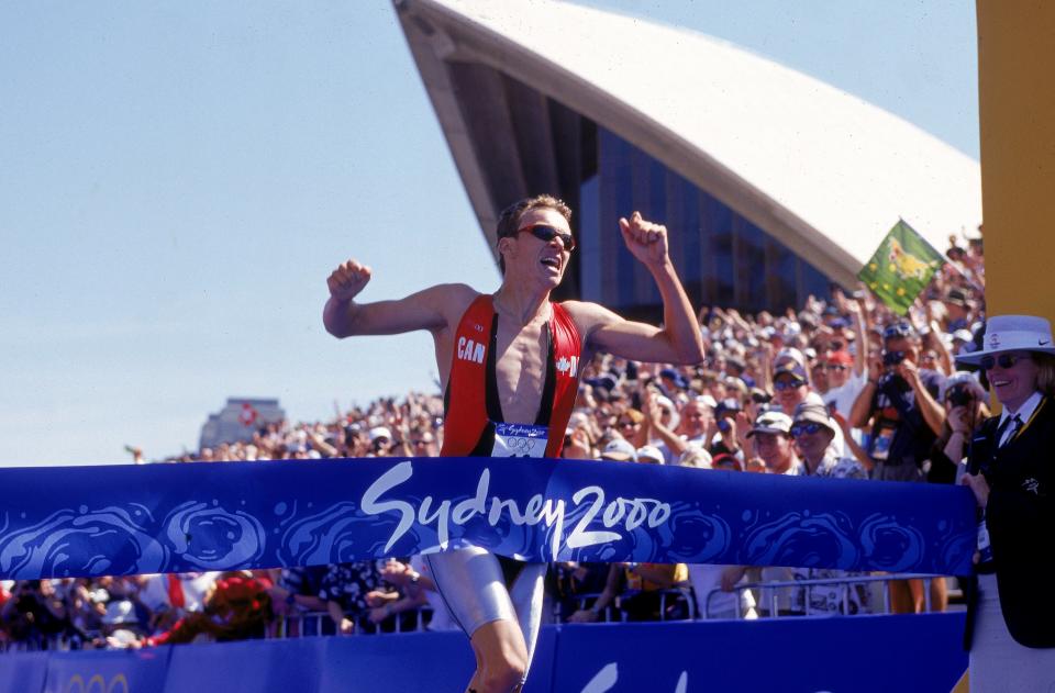 17 Sep 2000: Simon Whitfield of Canada crosses the finish line to win the Gold Medal in the Mens Triathlon during the 2000 Sydney Olympic Games at the Opera House in Sydney, Australia. Mandatory Credit: Adam Pretty/AUS /Allsport