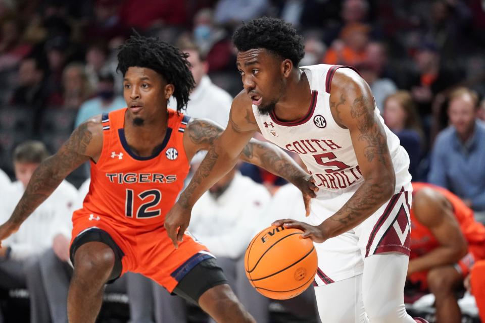 South Carolina guard Jermaine Couisnard (5) dribbles the ball against Auburn guard Zep Jasper (12) during the second half of an NCAA college basketball game Tuesday, Jan. 4, 2022, in Columbia, S.C. Auburn won 81-66. (AP Photo/Sean Rayford)