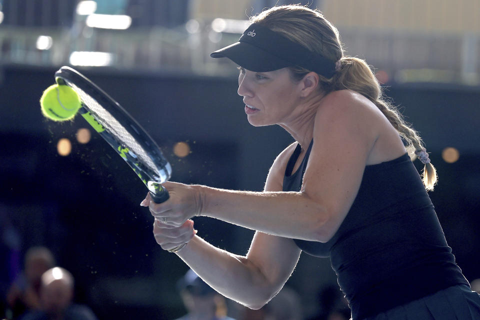 Danielle Collins of the U.S. makes a backhand return to Elena Rybakina of Kazakhstan during their Round of 32 match at the Adelaide International Tennis tournament in Adelaide, Australia, Monday, Jan. 2, 2023. (AP Photo/Kelly Barnes)