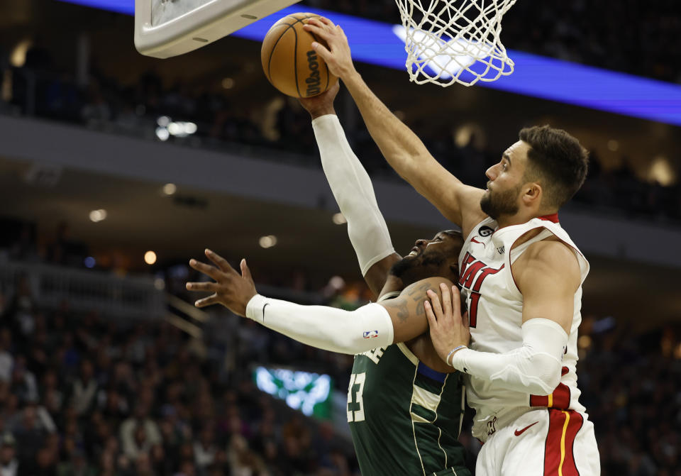 Miami Heat guard Max Strus, right, blocks a shot by Milwaukee Bucks guard Wesley Matthews during the second half of Game 5 in a first-round NBA basketball playoff series Wednesday, April 26, 2023, in Milwaukee. The Heat won 128-126 in overtime, eliminating the Bucks from the playoffs. (AP Photo/Jeffrey Phelps)