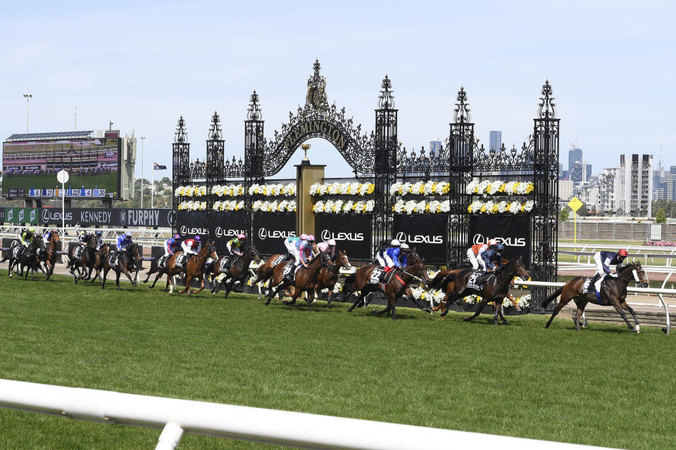 Twilight Payment, right, with jockey Jye McNeil on board leads at first past the post during the Melbourne Cup horse race at Flemington Racecourse in Melbourne, Australia, Tuesday, Nov. 3, 2020. (AP Photo/Andy Brownbill)