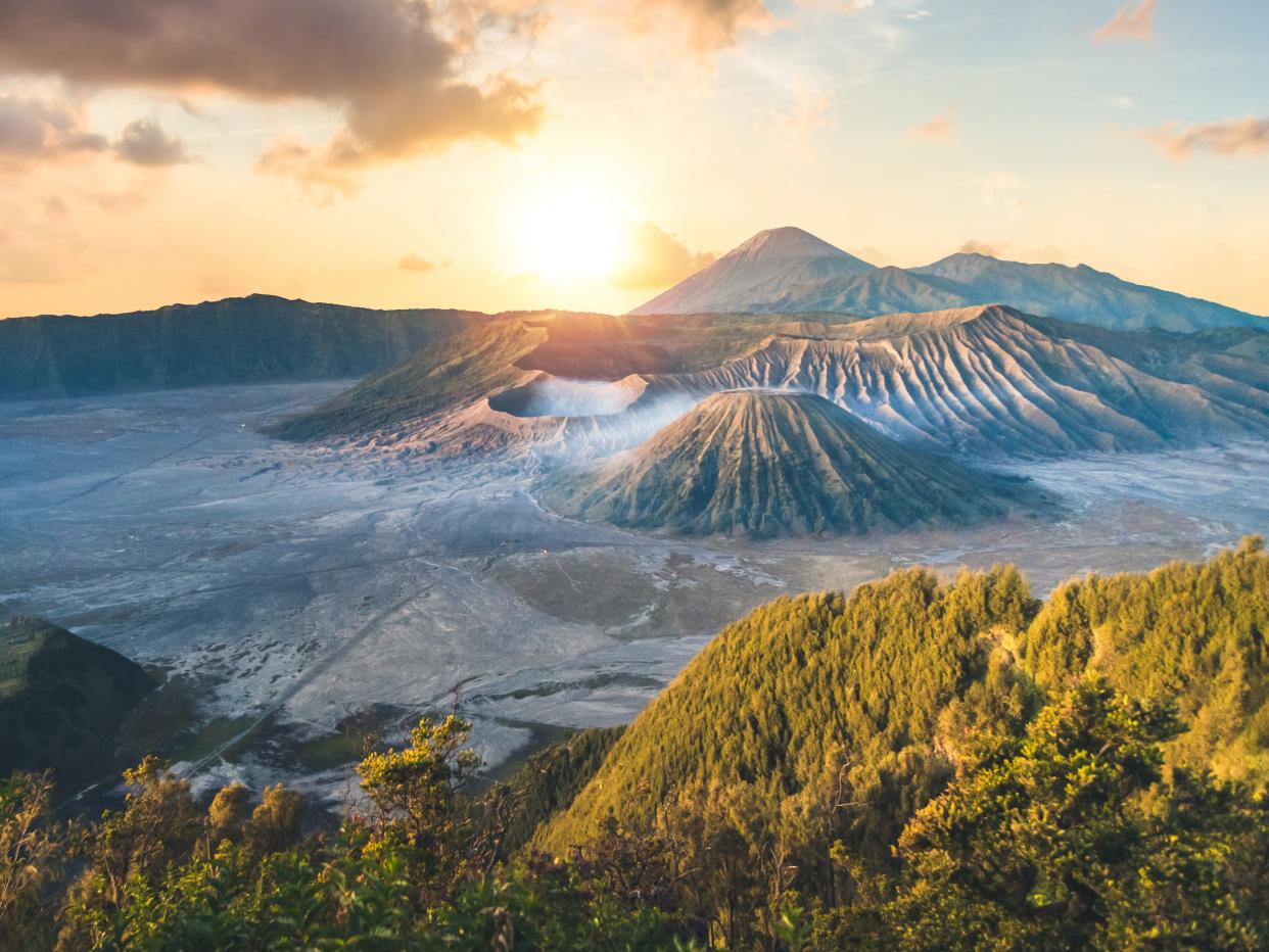 Early morning view of the Bromo caldeira in East Java in Indonesia. The volcanic formation of a few volcanoes, with the famous volcano Bromo and the Semeru volcano in the background stock photo