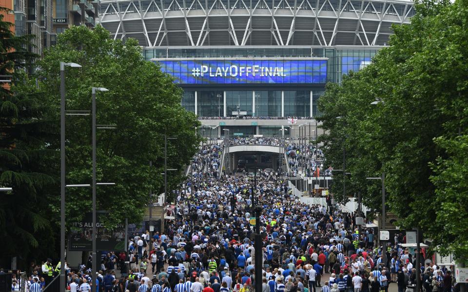 Fans make their way to the stadium prior to kickoff during the Sky Bet Championship play off  - Credit: GETTY IMAGES