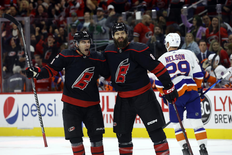 Carolina Hurricanes' Brent Burns (8) is congratulated on his goal by teammate Jordan Martinook, left, during the second period of an NHL hockey game against the New York Islanders in Raleigh, N.C., Friday, Oct. 28, 2022. (AP Photo/Karl B DeBlaker)