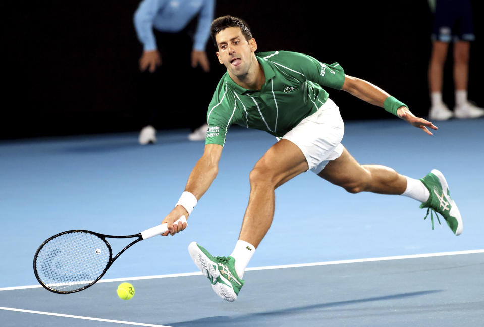 Serbia's Novak Djokovic reaches for a forehand return to Germany's Jan-Lennard Struff during their first round singles match the Australian Open tennis championship in Melbourne, Australia, Monday, Jan. 20, 2020. (AP Photo/Lee Jin-man)