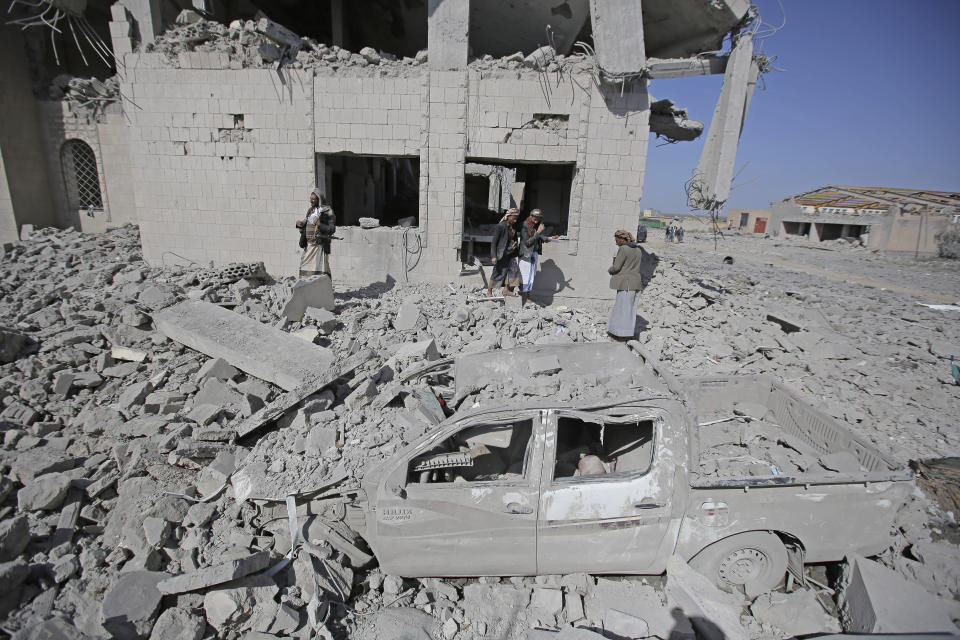 People inspect a Houthi detention center destroyed by Saudi-led airstrikes, that killed at least 60 people and wounding several dozen according to officials and the rebels' health ministry, in Dhamar province, southwestern Yemen, Sunday, Sept. 1, 2019. The officials said the airstrikes took place Sunday and targeted a college in the city of Dhamar, which the Houthi rebels use as a detention center. The Saudi-led coalition said it had hit a Houthi military facility used as storages for drones and missiles in Dhamar. (AP Photo/Hani Mohammed)