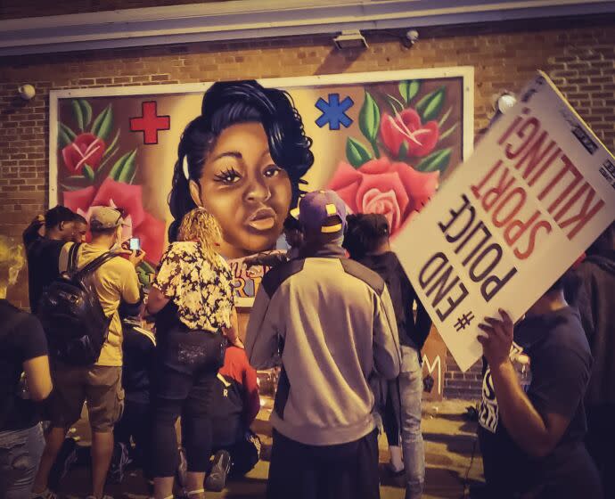 Protesters gather at a mural of Breonna Taylor in Milwaukee.