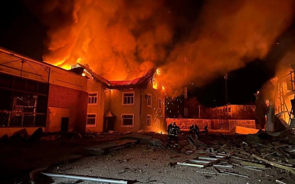 Firemen work at a factory set alight by a Russian drone strike overnight in Bila Tserkva, south of Kyiv