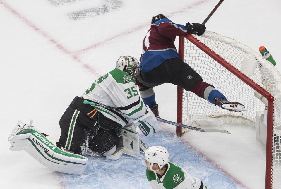 Colorado Avalanche's Tyson Jost (17) crashes into Dallas Stars' goalie Anton Khudobin (35) during the first period of an NHL hockey Stanley Cup playoff game in Edmonton, Alberta, Friday, Sept. 4, 2020. (Jason Franson/The Canadian Press via AP)