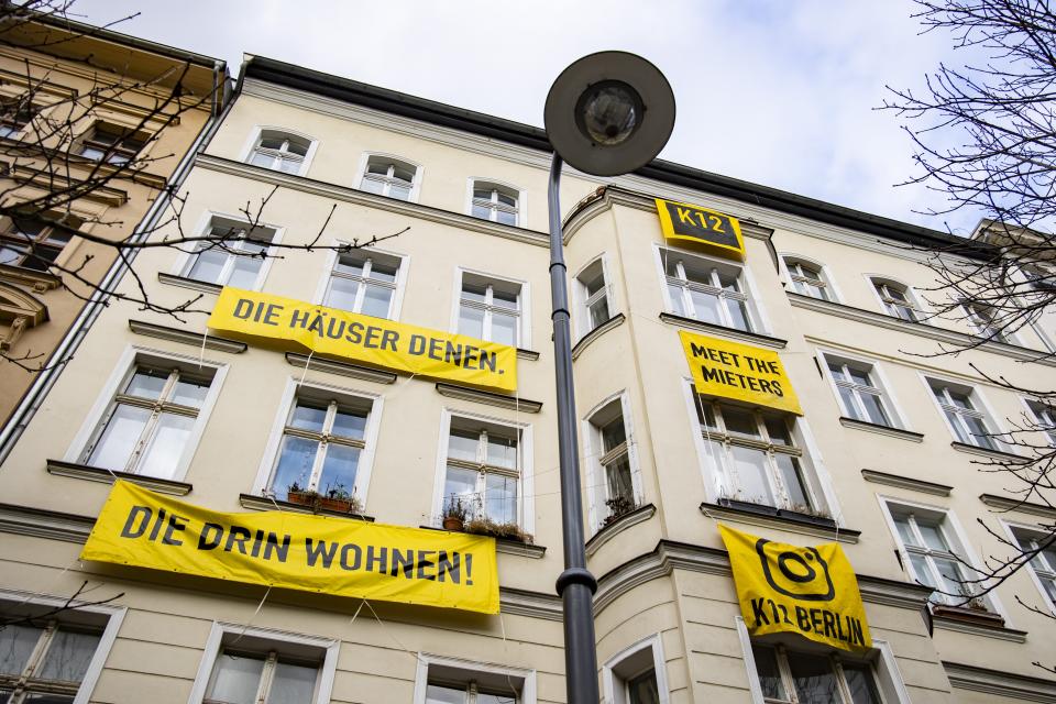 Banners reading 'The houses to those, who live inside them' are seen hanging on a facade of a house in Prenzlauer Berg in Berlin, Germany on February 2, 2023.