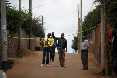 Kenyan policemen in civilian clothes stand guard near the house of a man suspected of taking part in the attack on a hotel and office complex in Nairobi, in Kiambu, Kenya, January 16, 2019. Picture taken January 16, 2019. REUTERS/Baz Ratner