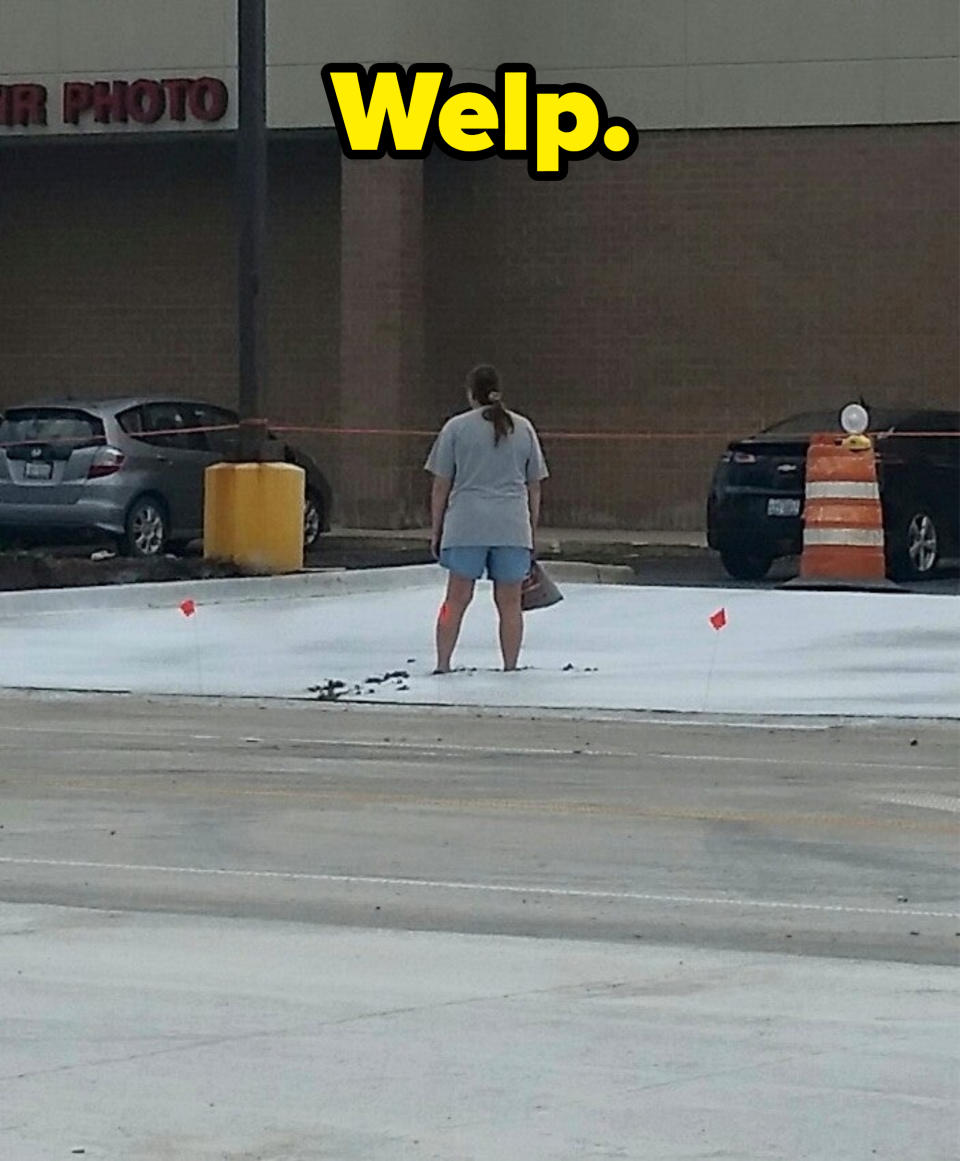 A person standing in wet concrete