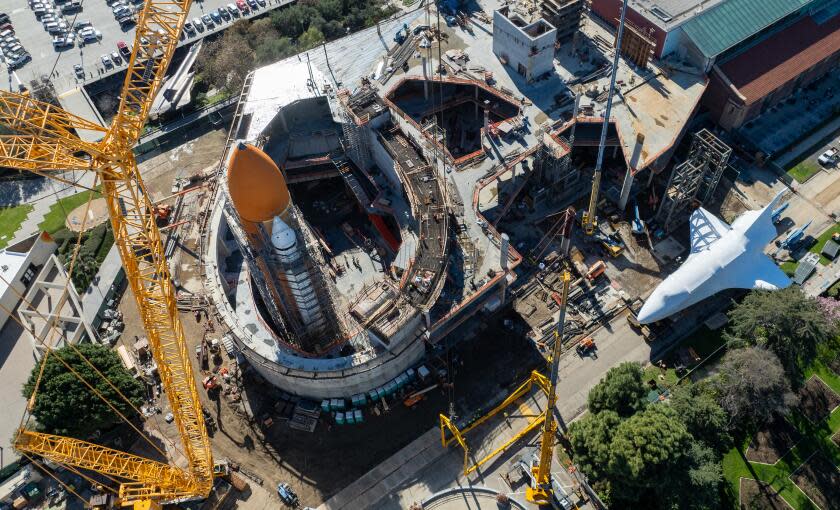 Los Angeles, CA - January 26: The space shuttle Endeavour is wrapped in protective shrink wrap and is parked next to external fuel tanks and is anticipated to be lifted by a 450-foot crane and mated to there tanks in full launch position in the next few days, weather permitting at the future Samuel Oschin Air and Space Center in on Friday, Jan. 26, 2024 in Los Angeles, CA. (Brian van der Brug / Los Angeles Times)