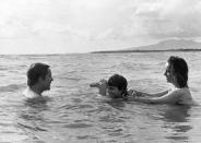 <p>Richard Burton is joined by his wife, Elizabeth Taylor, and his step-daughter Liza Todd, for a dip in the ocean while they are in Mexico filming Night of the Iguana in 1963. </p>