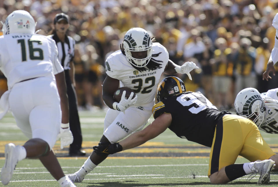 Colorado State running back Marcus McElroy Jr. (32) is tackled by Iowa defensive lineman John Waggoner (92) during the first quarter of an NCAA college football game, Saturday, Sept. 25, 2021, in Iowa City, Iowa. (AP Photo/Ron Johnson)
