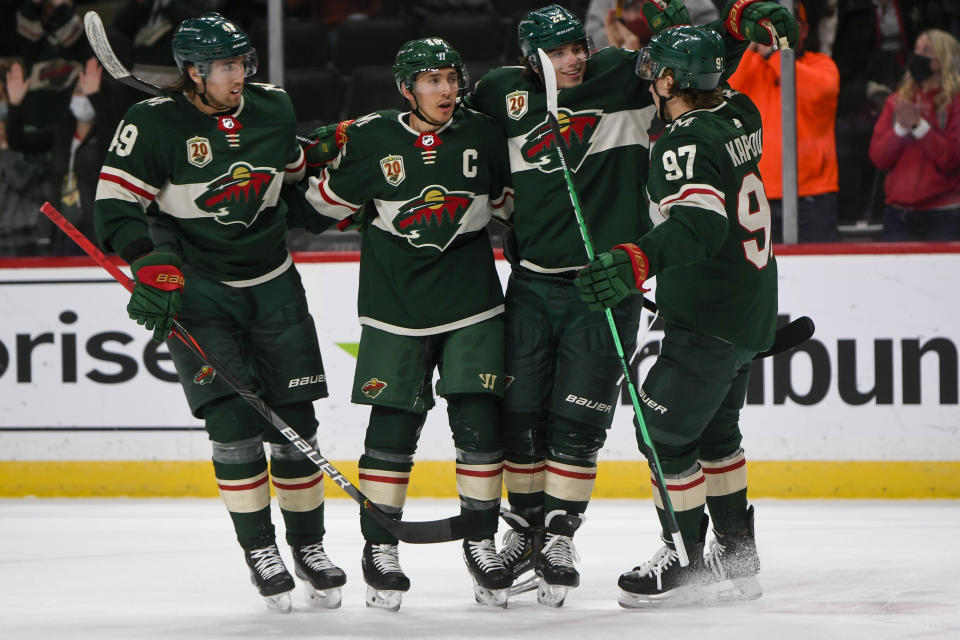 Minnesota Wild center Victor Rask, defenseman Jared Spurgeon, left wing Kevin Fiala and left wing Kirill Kaprizov, from left, celebrate after Spurgeon scored a goal against the Anaheim Ducks with an assist from Kaprizov during the first period of an NHL hockey game Saturday, May 8, 2021, in St. Paul, Minn. (AP Photo/Craig Lassig)