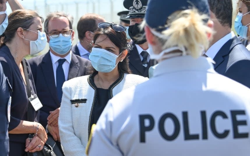 Priti Patel (centre) meets French police and border officials yesterday in Calais. CREDIT: AFP - DENIS CHARLET /AFP