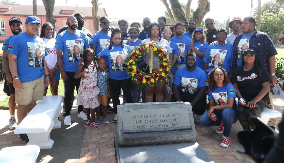 Freedom riders on the Stay Woke Rolling Votercade buses gather at the grave of Mary McLeod Bethune  to lay a wreath, Friday June 23, 2023 during a stop in Daytona Beach.