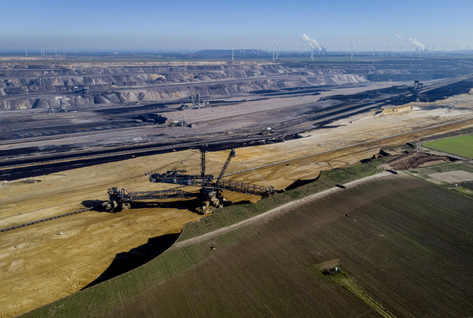 A bucket wheel excavator is mining coal at the Garzweiler open-cast coal mine in Luetzerath, Germany, Sunday, Oct. 24, 2021. The climate change conference COP26 will start next Sunday in Glasgow, Scotland. (AP Photo/Michael Probst)