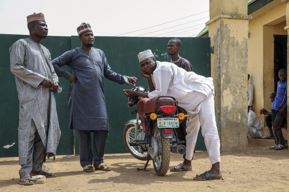 From left, Kabiru Abdullahi Dangebe, who has five daughters missing, Isah Sulaiman, whose daughter is missing, Ismail Ladan, whose daughter is missing, and Luman Bala, whose younger sister is missing, wait for news of the more than 300 girls who were abducted by gunmen on Friday from the Government Girls Junior Secondary School, in Jangebe town, Zamfara state, northern Nigeria Sunday, Feb. 28, 2021. Families in Nigeria waited anxiously on Sunday for news of their abducted daughters, the latest in a series of mass kidnappings of school students in the West African nation. (AP Photo/Ibrahim Mansur)