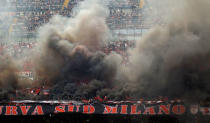 Football Soccer - Inter Milan v AC Milan - Italian Serie A - San Siro Stadium, Milan, Italy - 15/04/17 AC Milan supporters light flares on the tribune . REUTERS/Alessandro Garofalo