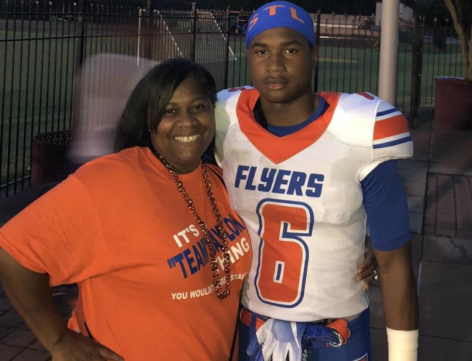 Jaylon McKenzie poses with his mother, Sukeena Gunner, at an East St. Louis Junior Flyers football game.