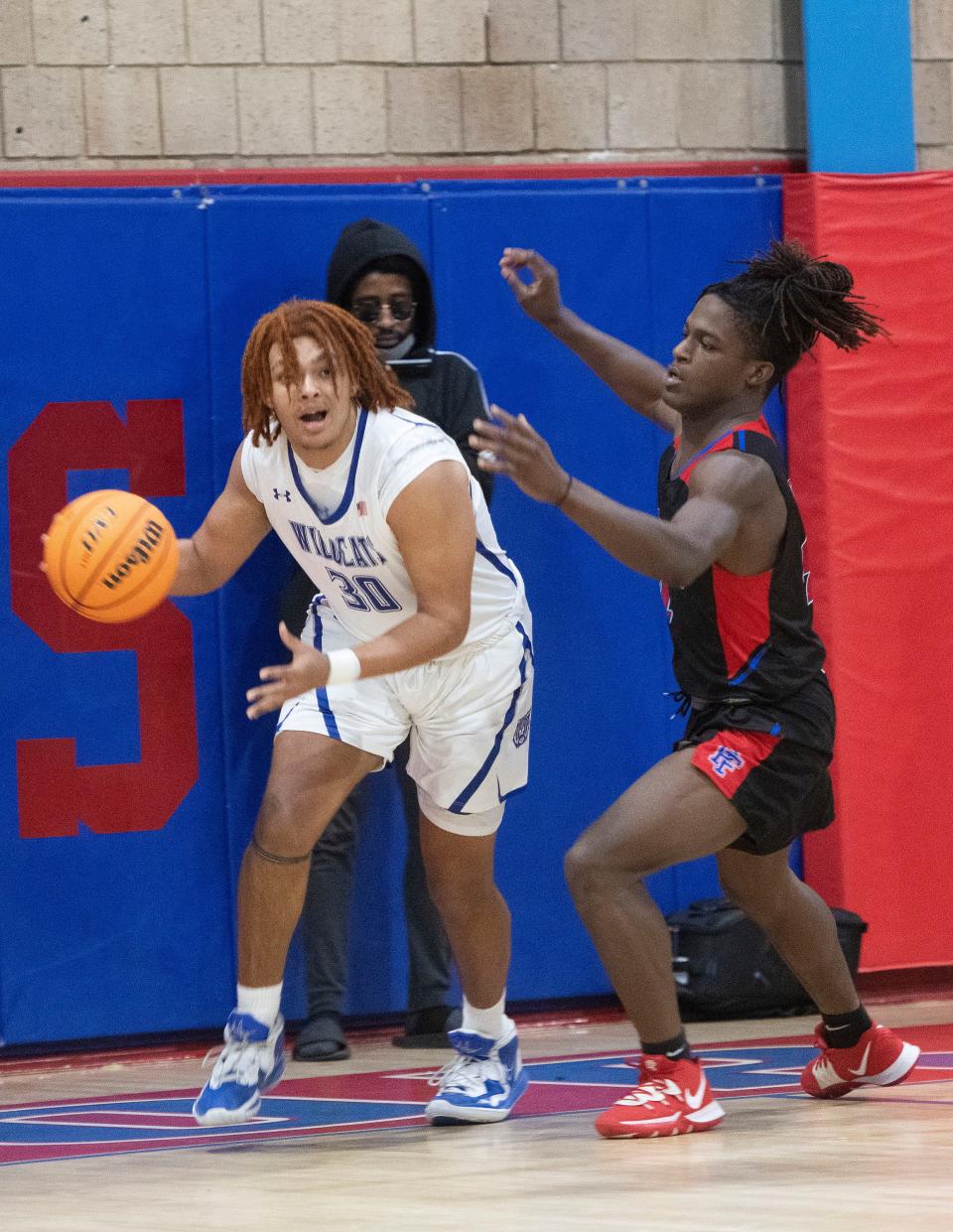 Washington High School's Tristan Dennis (No. 30) tries to drive past Pine Forest High School's Hasshawn Hackworth (No. 4) during the District 1-5A quarterfinal on Wednesday, Feb. 8, 2023.