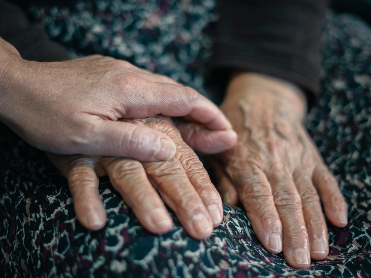 Close-up Adult woman and old woman holding hands