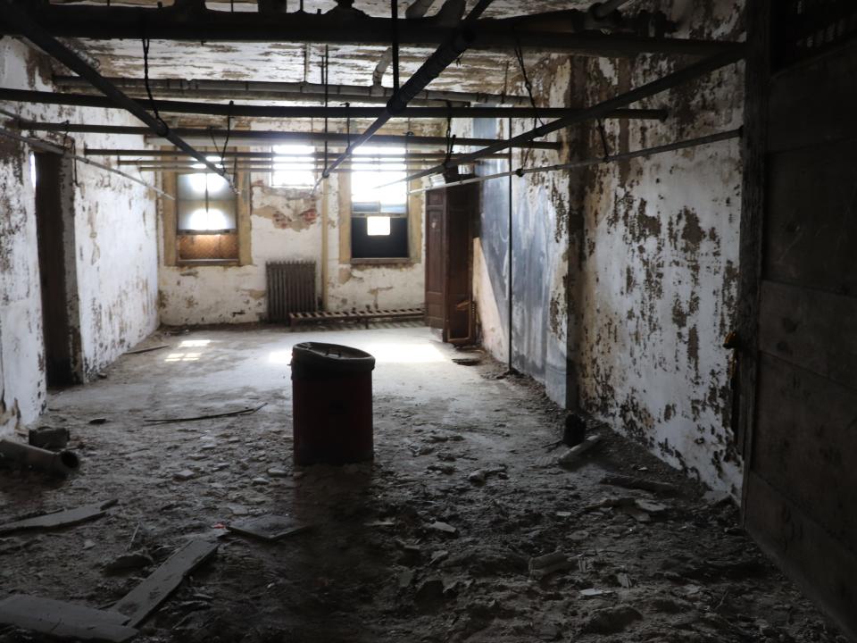 an abandoned room at the ellis island hospital filled with debris