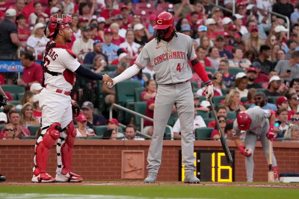 Elly De La Cruz shakes hands with Cardinals catcher Willson Contreras before her first at bat on Friday.