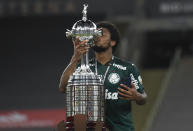 Luiz Adriano of Brazil's Palmeiras kisses the trophy after winning the Copa Libertadores final soccer match against Brazil's Santos at the Maracana stadium in Rio de Janeiro, Brazil, Saturday, Jan. 30, 2021. Palmeiras won 1-0. (Mauro Pimentel/Pool via AP)