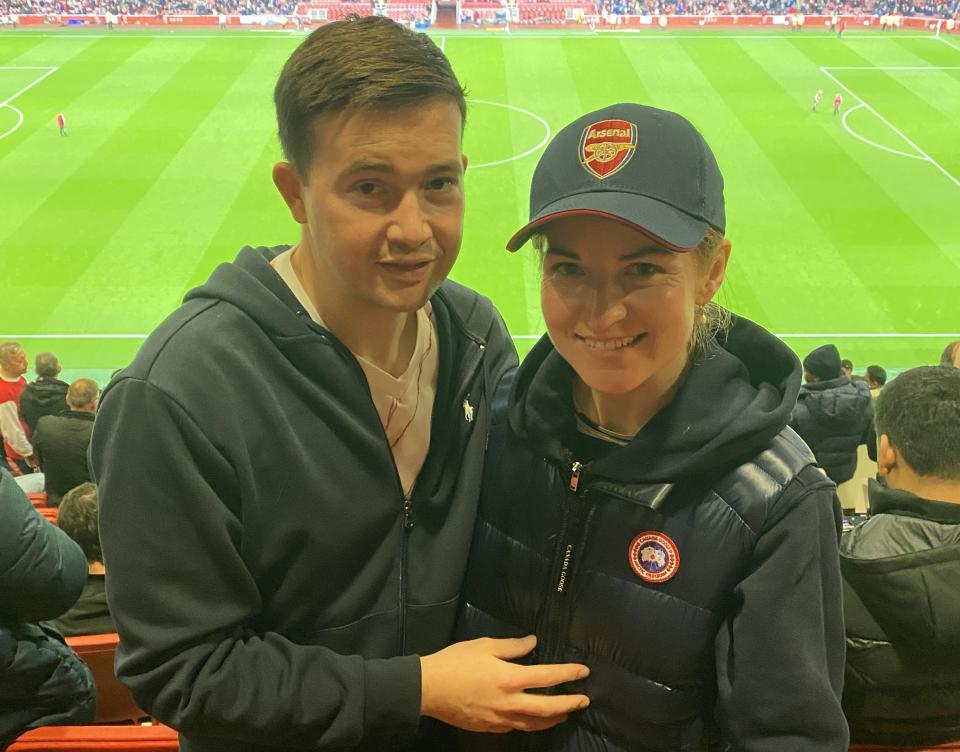 With his wife, both Arsenal fans, at the Emirates Stadium