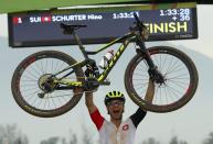 <p>Nino Schurter (SUI) of Switzerland celebrates winning the gold medal. (Reuters) </p>