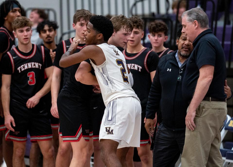 William Tennent's Kirby Mooney (1) gets a congratulatory hug from Upper Moreland's Alex Best (2) after scoring his 1,000th point against Upper Moreland during their boys’ basketball game in Willow Grove on Thursday, Dec. 7, 2023.

[Daniella Heminghaus | Bucks County Courier Times]