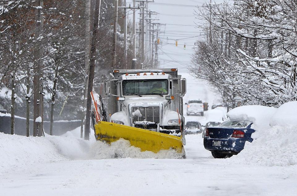 A city of Erie plow driver clears a portion of Cherry Street on Dec. 26, 2017, after several feet of snow fell on the city and surrounding areas over two days.