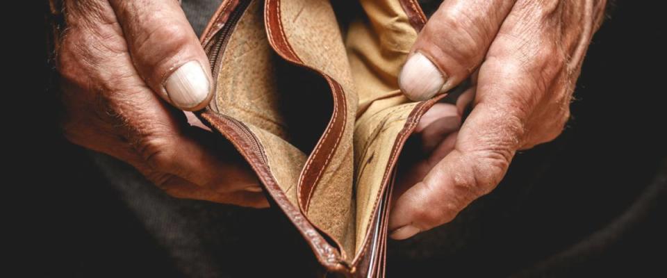 elderly man with empty wallet