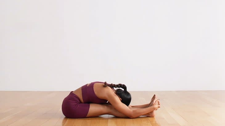 Woman demonstrates Seated Forward Bend
