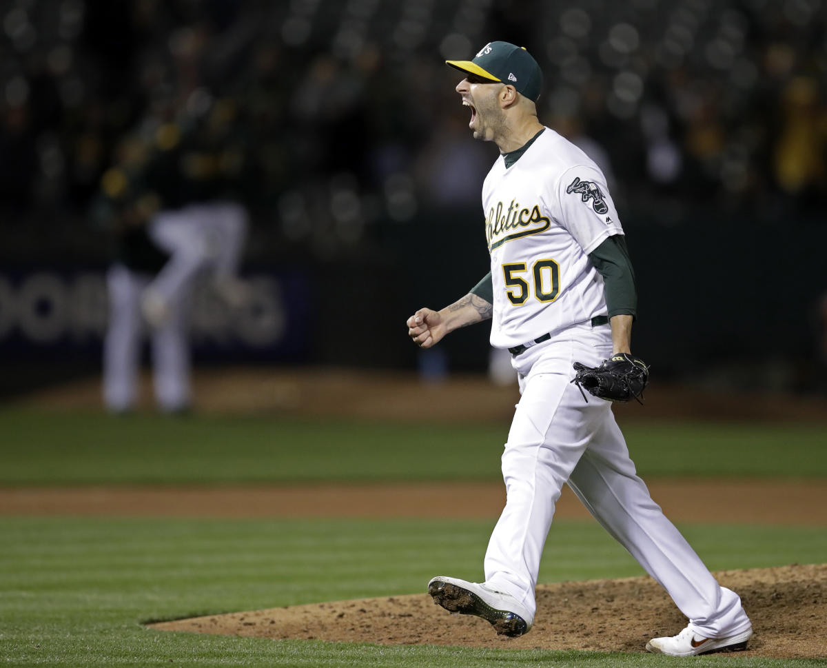 Oakland Athletics' Mike Fiers, center, celebrates with Matt Olson