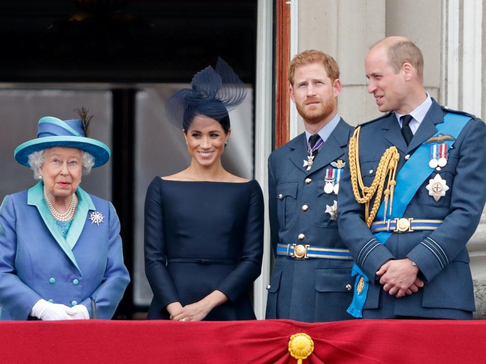 Queen Elizabeth II, Meghan Markle, Prince Harry, and Prince William on the palace balcony.