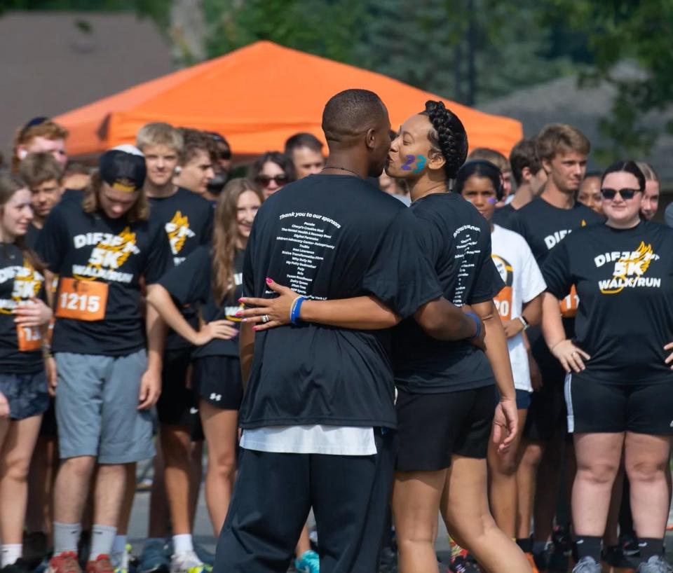Tamia Woods kisses her husband, Tim, during a race in August to raise money from the Do it for James Foundation they created in honor of their late son James. The race was on the couple's wedding anniversary.