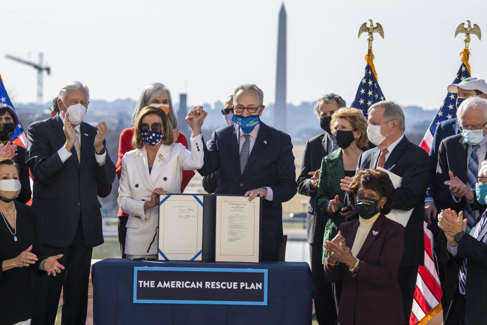 UNITED STATES - MARCH 10: Speaker of the House Nancy Pelosi, D-Calif., and Senate Majority Leader Chuck Schumer, D-N.Y., celebrate signing the American Rescue Plan Act at a bill enrollment ceremony on the West Front of the Capitol after the House passed the $1.9 trillion covid-19 relief package on Wednesday, March 10, 2021. (Photo By Tom Williams/CQ-Roll Call, Inc via Getty Images)