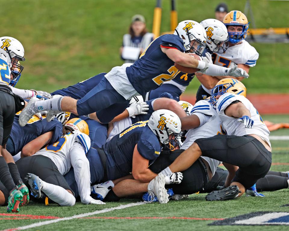 Siena Heights' Ethan LoPresto dives in for a touchdown during Saturday's game against Madonna.
