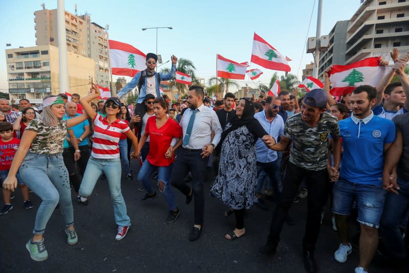 Demonstartors dance during an anti-government protest in the southern city of Tyre