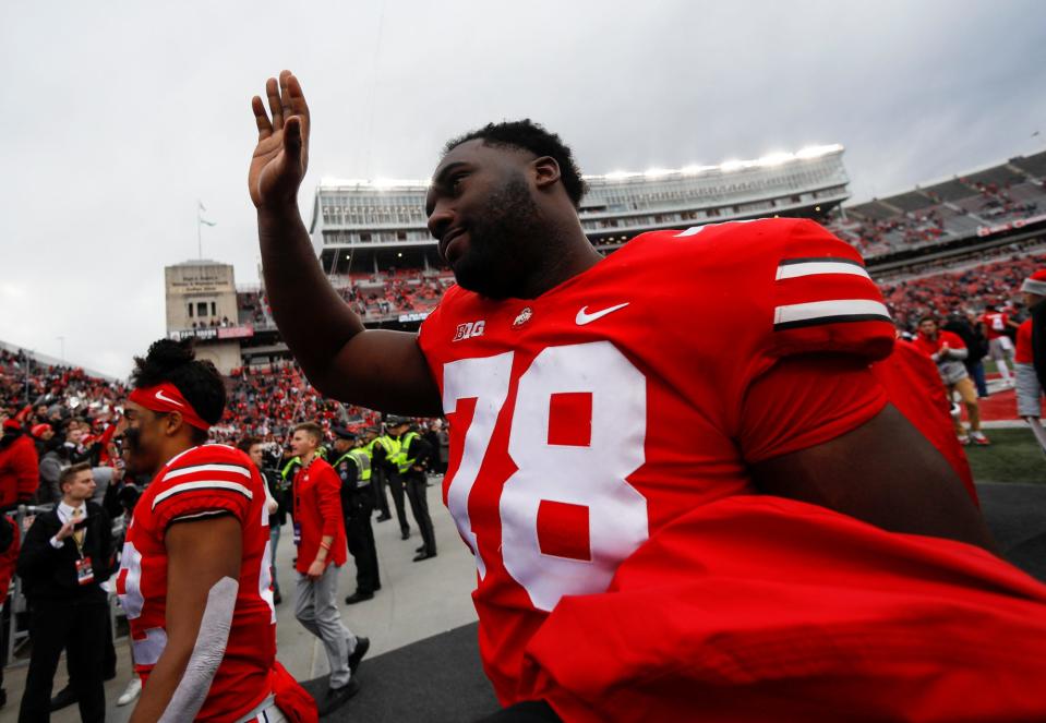 Ohio State Buckeyes offensive tackle Nicholas Petit-Frere (78) waves to the crowd as he leaves the field following their 56-7 win over the Michigan State Spartans in the NCAA football game at Ohio Stadium in Columbus on Saturday, Nov. 20, 2021. Petit-Frere was honored earlier in the game during the Senior Day ceremony.