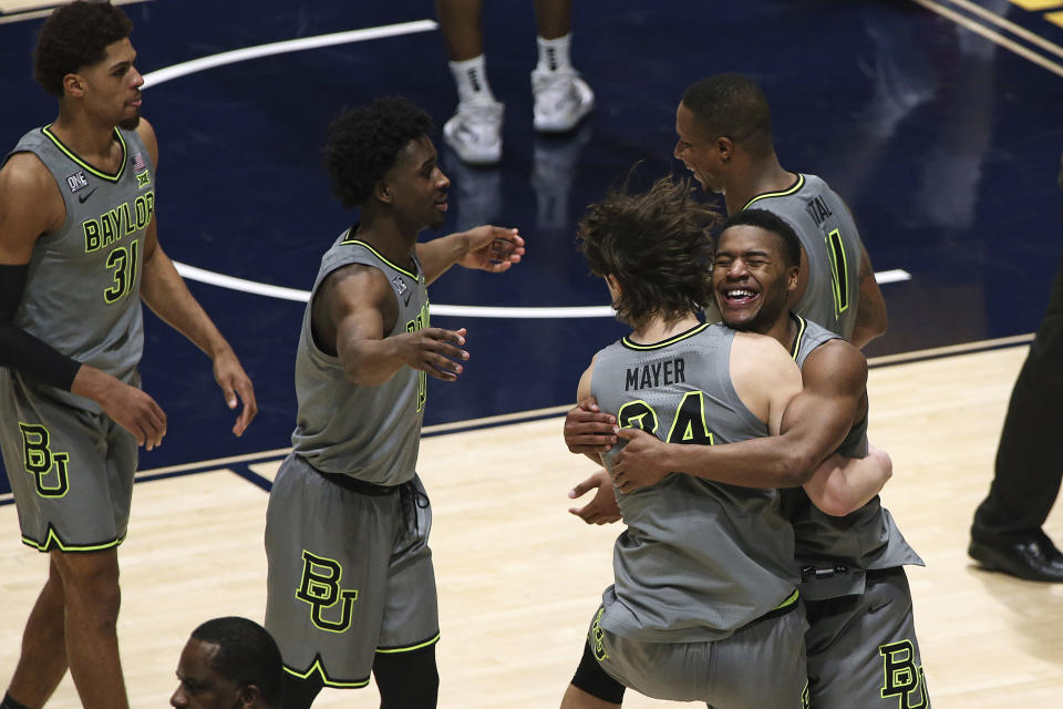 Baylor players celebrate an overtime win over West Virginia in an NCAA college basketball game Tuesday, March 2, 2021, in Morgantown, W.Va. (AP Photo/Kathleen Batten)