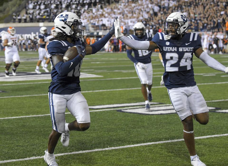 Utah State cornerback Jaiden Francois (10) and cornerback Gabriel Bryan (24) celebrate as Francois returns an interception for a touchdown during the second half of an NCAA college football game against Idaho State on Saturday, Sept. 9, 2023, in Logan, Utah. | Eli Lucero/The Herald Journal via AP