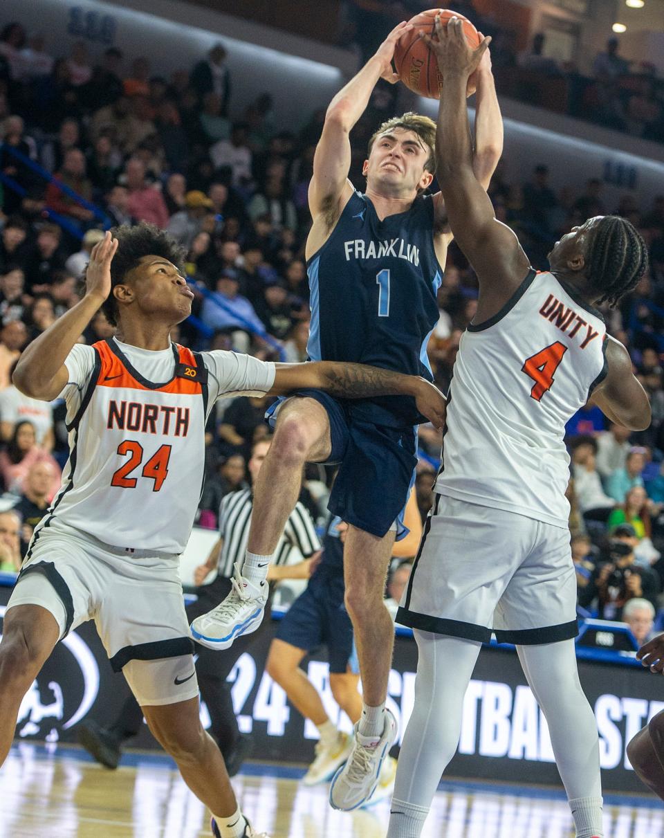 Franklin High School junior Caden Sullivan splits the Worcester North defense in the Div. 1 state boys basketball final at the Tsongas Center in Lowell, March 17, 2024.